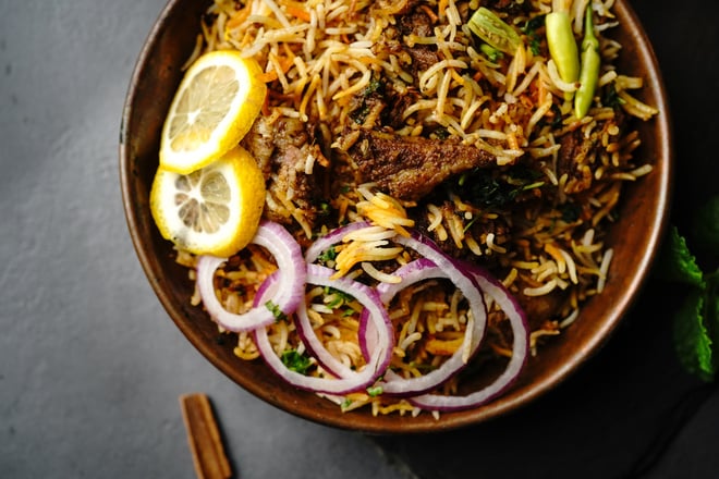 Hyderabadi Mutton goat biryani served with yogurt raita on moody setting